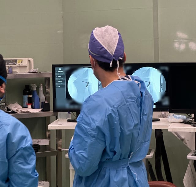 Dr. Danial Sharifi Razavi checking X-ray images during an operation