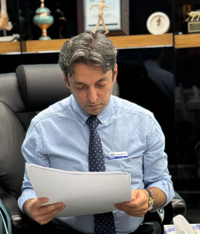 Dr. Danial Sharifi Razavi at his desk in his consulting room at the clinic